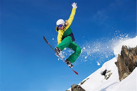 snowboarder jumping - Young female snowboarder jumping Stock Photo - Premium Royalty-Free, Code: 649-06844034