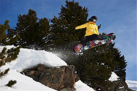 simsearch:649-06844041,k - Young female snowboarder jumping Stock Photo - Premium Royalty-Free, Code: 649-06844035