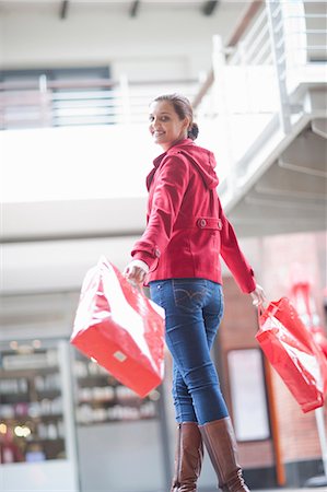 shopping mall interior images - Young woman carrying shopping bags Stock Photo - Premium Royalty-Free, Code: 649-06844179