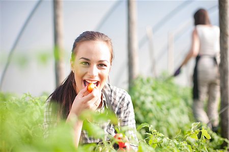 summer vegetable - Young woman trying produce at vegetable farm Stock Photo - Premium Royalty-Free, Code: 649-06844238