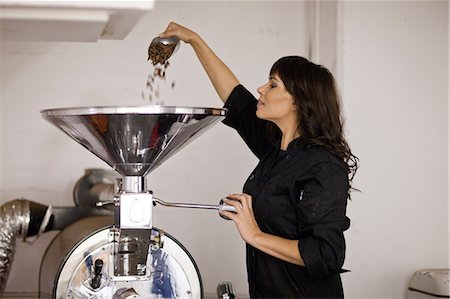 simsearch:649-06844316,k - Woman pouring cocoa beans into funnel Stock Photo - Premium Royalty-Free, Code: 649-06844314