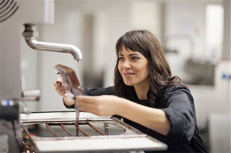 simsearch:614-03551539,k - Woman working in commercial kitchen with melted chocolate Stock Photo - Premium Royalty-Free, Code: 649-06844324