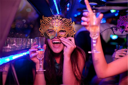 party indoors night - Young woman wearing mask with wine glass in limousine Stock Photo - Premium Royalty-Free, Code: 649-06844361