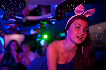 Young woman wearing bunny ears in limousine Stock Photo - Premium Royalty-Free, Code: 649-06844363