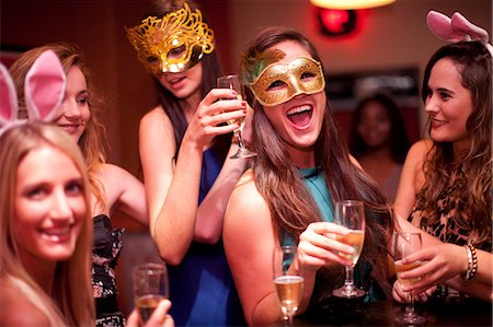 Young women with drinks wearing masks at hen party Stock Photo - Premium Royalty-Free, Code: 649-06844379