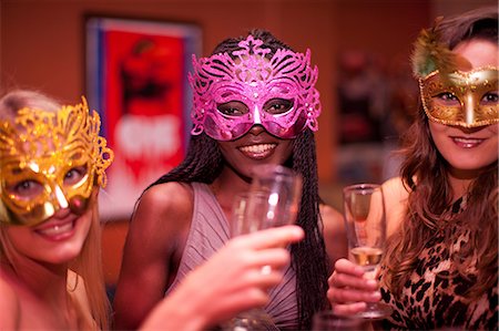 Young women wearing masquerade masks at hen party Stock Photo - Premium Royalty-Free, Code: 649-06844385