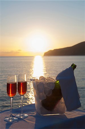 festive and wine - Wine glasses and bottle in ice bucket with sea in background Stock Photo - Premium Royalty-Free, Code: 649-06844400