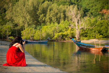 Woman photographing boats, Taling Ngam Beach, Ko Samui, Thailand Stock Photo - Premium Royalty-Free, Code: 649-06844512