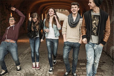 Five teenagers walking through tunnel laughing and joking Stock Photo - Premium Royalty-Free, Code: 649-06844583