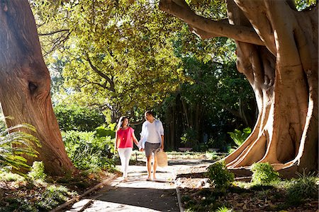 front yard - Young couple walking on path through trees Stock Photo - Premium Royalty-Free, Code: 649-06844616