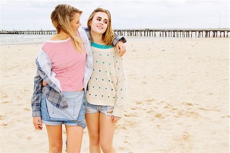 person sand - Girlfriends standing on beach with arm around Stock Photo - Premium Royalty-Free, Code: 649-06844676