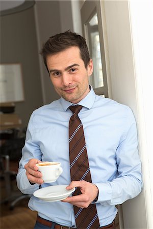 Mature man wearing shirt and tie holding cup of coffee Stock Photo - Premium Royalty-Free, Code: 649-06844792