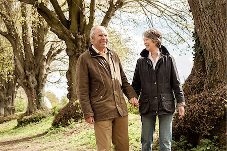 Husband and wife holding hands walking in park Stock Photo - Premium Royalty-Free, Code: 649-06844981