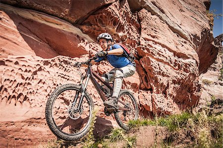 excited sport - Man mountain biking next to rocks Stock Photo - Premium Royalty-Free, Code: 649-06845142