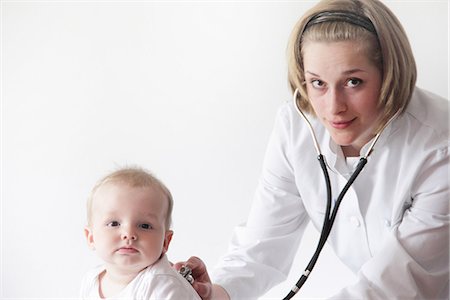 simsearch:649-08232742,k - Female doctor examining baby's breathing Stock Photo - Premium Royalty-Free, Code: 649-06845235