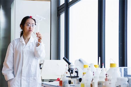 Female scientist examining glass tubes Stock Photo - Premium Royalty-Free, Code: 649-06845244