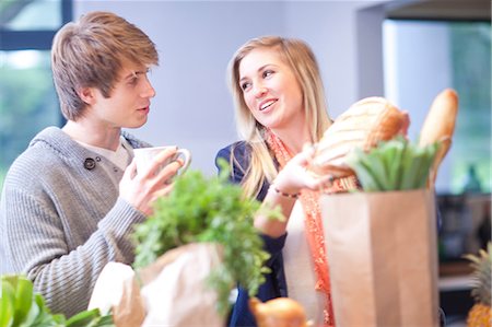 someone holding a mug - Young woman unpacking shopping Stock Photo - Premium Royalty-Free, Code: 649-07064015