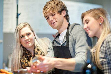 Young adults preparing food in kitchen Stock Photo - Premium Royalty-Free, Code: 649-07064027