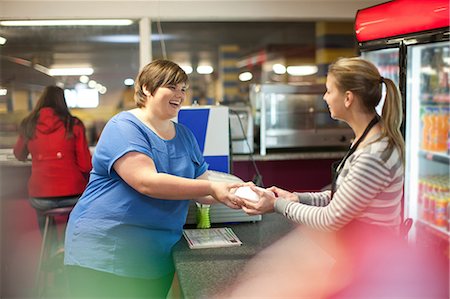 food and fast food - Young woman collecting takeaway order in cafe Stock Photo - Premium Royalty-Free, Code: 649-07064054