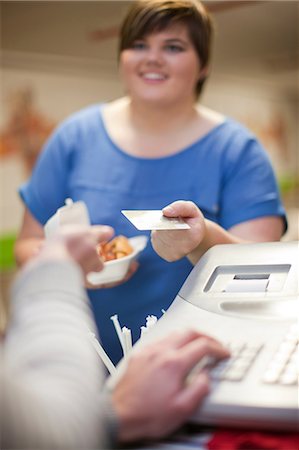 fat women eating food - Young woman paying for takeaway order in cafe Stock Photo - Premium Royalty-Free, Code: 649-07064055