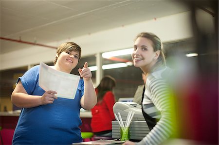 Young woman ordering from menu in cafe Stock Photo - Premium Royalty-Free, Code: 649-07064053