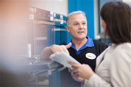 shopping in the store - Woman negotiating with salesman in showroom Stock Photo - Premium Royalty-Free, Code: 649-07064068