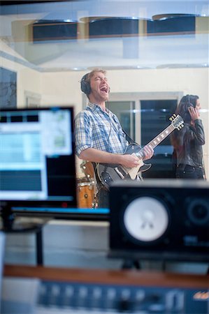 pictures of musicians with headphones - Young band playing in studio Stock Photo - Premium Royalty-Free, Code: 649-07064116