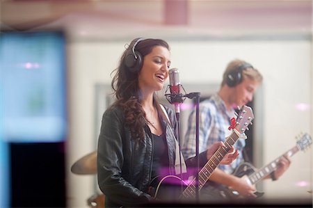 pictures of musicians with headphones - Young band playing music in recoding studio Stock Photo - Premium Royalty-Free, Code: 649-07064122