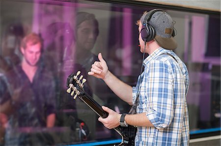 pictures of musicians with headphones - Young guitarist in recording studio Stock Photo - Premium Royalty-Free, Code: 649-07064130