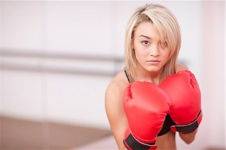 female motivating - Portrait of young woman in boxing gloves Stock Photo - Premium Royalty-Free, Code: 649-07064162