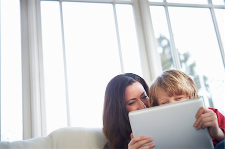 parent computer - Mother and son on sofa using digital tablet Stock Photo - Premium Royalty-Free, Code: 649-07064251