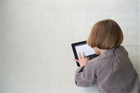 fun toddler - Girl lying on floor using digital tablet Stock Photo - Premium Royalty-Free, Code: 649-07064263