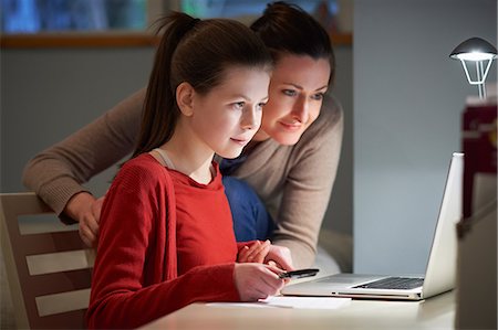 parent and teen at computer - Girl using laptop computer Stock Photo - Premium Royalty-Free, Code: 649-07064282