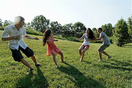 simsearch:649-07239411,k - Group of young adults playing tug of war Photographie de stock - Premium Libres de Droits, Code: 649-07064328