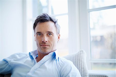 relaxing at home - Portrait of businessman relaxing at home Stock Photo - Premium Royalty-Free, Code: 649-07064538