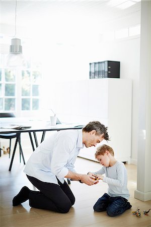 father and son playing with toys - Father and son playing with toys Stock Photo - Premium Royalty-Free, Code: 649-07064552