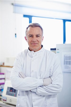 Portrait of researcher standing in lab wearing lab coat Stock Photo - Premium Royalty-Free, Code: 649-07064741