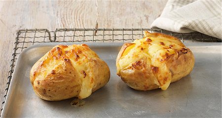 quality dairy - Baked potatoes with cheese on metal baking sheet Stock Photo - Premium Royalty-Free, Code: 649-07062969