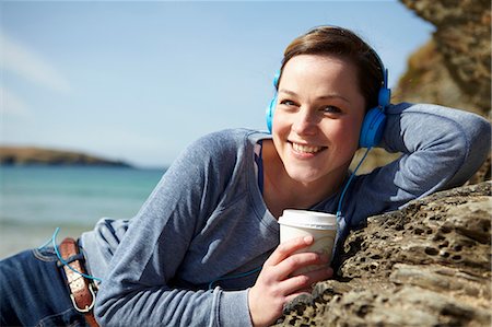 simsearch:649-07063009,k - Portrait of young woman at coast with coffee and earphones Stock Photo - Premium Royalty-Free, Code: 649-07062996