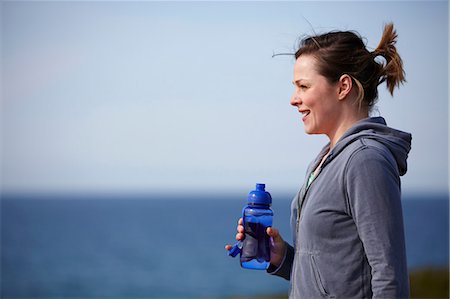 fitness water bottle - Young woman at coast taking exercise break Stock Photo - Premium Royalty-Free, Code: 649-07063009