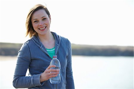 Portrait of young woman at coast taking exercise break Stock Photo - Premium Royalty-Free, Code: 649-07063010