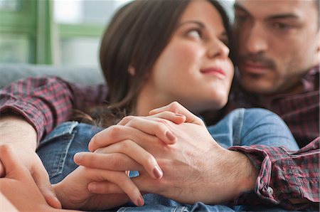 Close up of romantic young couple on sofa Stock Photo - Premium Royalty-Free, Code: 649-07063154