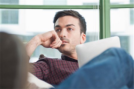 Close up of young man at home with digital tablet Fotografie stock - Premium Royalty-Free, Codice: 649-07063166