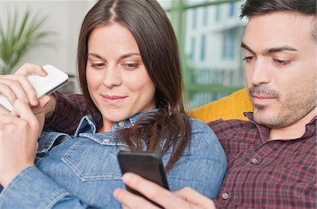 people reclining images - Young couple at home with mobile phones Stock Photo - Premium Royalty-Free, Code: 649-07063160