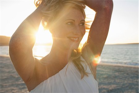 relax beach pose - Close up of blond woman on beach at dusk, Cape Town, South Africa Stock Photo - Premium Royalty-Free, Code: 649-07063176