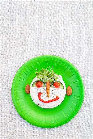 face expression happy - Face made from fresh food on green plate Stock Photo - Premium Royalty-Free, Code: 649-07063179