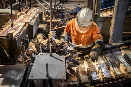 protective glove - Worker testing metal ingots at aluminum recycling plant Stock Photo - Premium Royalty-Free, Code: 649-07063376