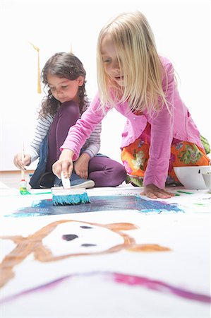 diverse happy children - Two girls painting on floor Stock Photo - Premium Royalty-Free, Code: 649-07063443