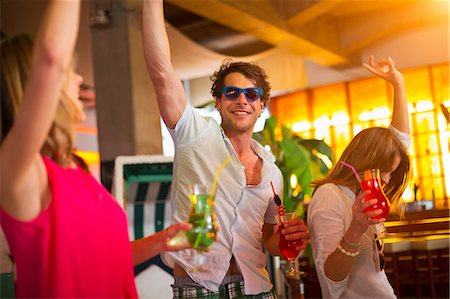 pictures of people dancing in a club - Group of friends dancing with cocktails in bar Stock Photo - Premium Royalty-Free, Code: 649-07063535