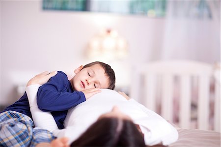 pregnant woman sleep - Young boy quietly resting on his mothers bump Stock Photo - Premium Royalty-Free, Code: 649-07063639